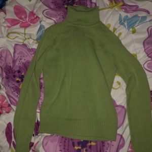 A green turtle Neck sweater